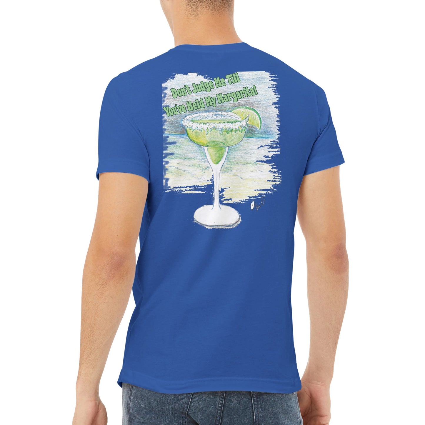 A true royal blue premium unisex v-neck t-shirt with original artwork and motto Dont Judge Me Till You've Held My Margarita on back and WhatYa Say logo on front made with combed and ring-spun cotton from WhatYa Say Apparel worn by A brown-haired male back view.