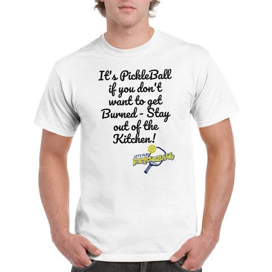 A white comfortable Unisex Crewneck heavyweight cotton t-shirt with funny saying It’s PickleBall if you don’t want to get Burned – Stay out of the Kitchen! and Let’s Play Pickleball logo on the front from WhatYa Say Apparel worn by blonde-haired male front view.