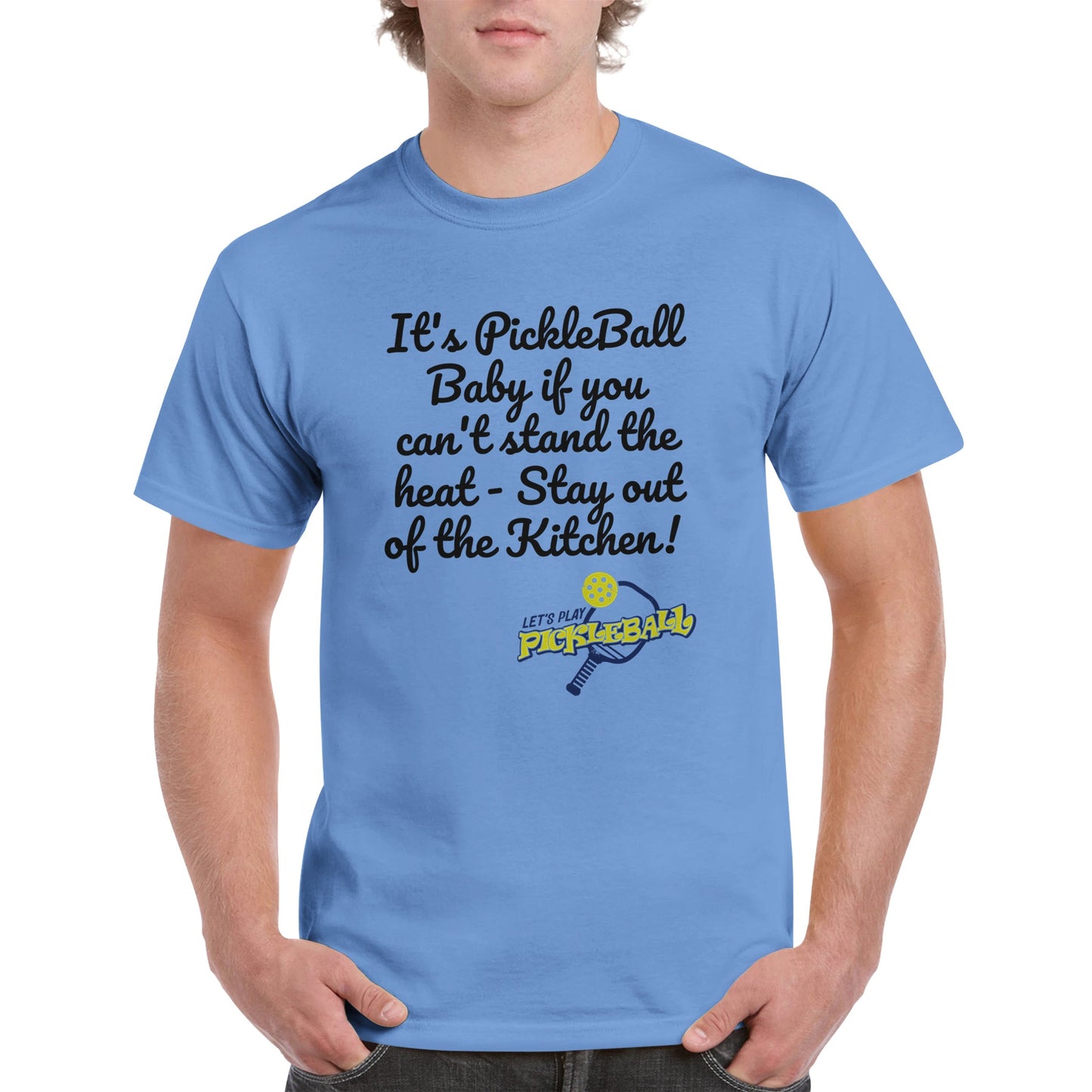 Carolina Blue comfortable Unisex Crewneck heavyweight cotton t-shirt with funny saying It’s PickleBall Baby if can’t stand the heat – Stay out of the Kitchen!  and Let’s Play Pickleball logo on the front from WhatYa Say Apparel worn by blonde-haired male front view.