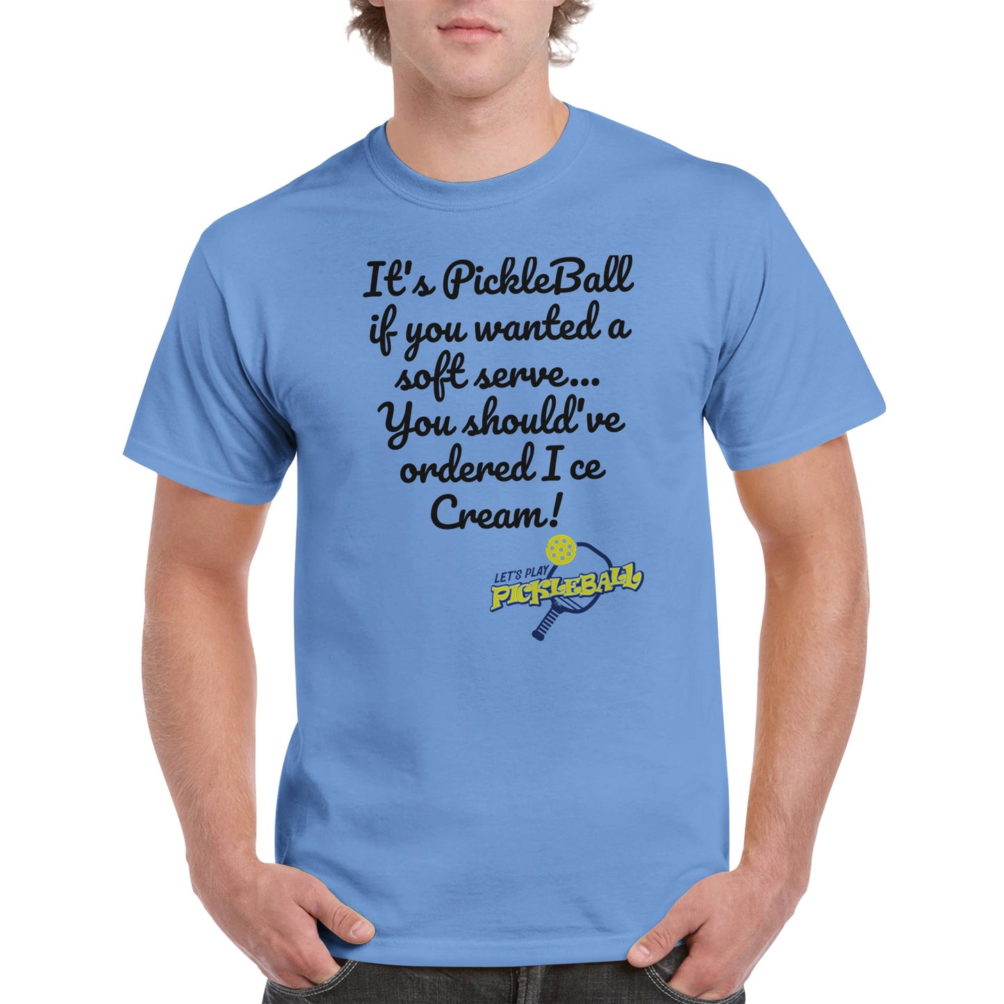 Carolina Blue Unisex Crewneck heavyweight cotton t-shirt with funny saying It’s PickleBall if you wanted a soft serve… You should’ve ordered Ice Cream! and Let’s Play Pickleball logo on the front from WhatYa Say Apparel worn by blonde-haired male front view.