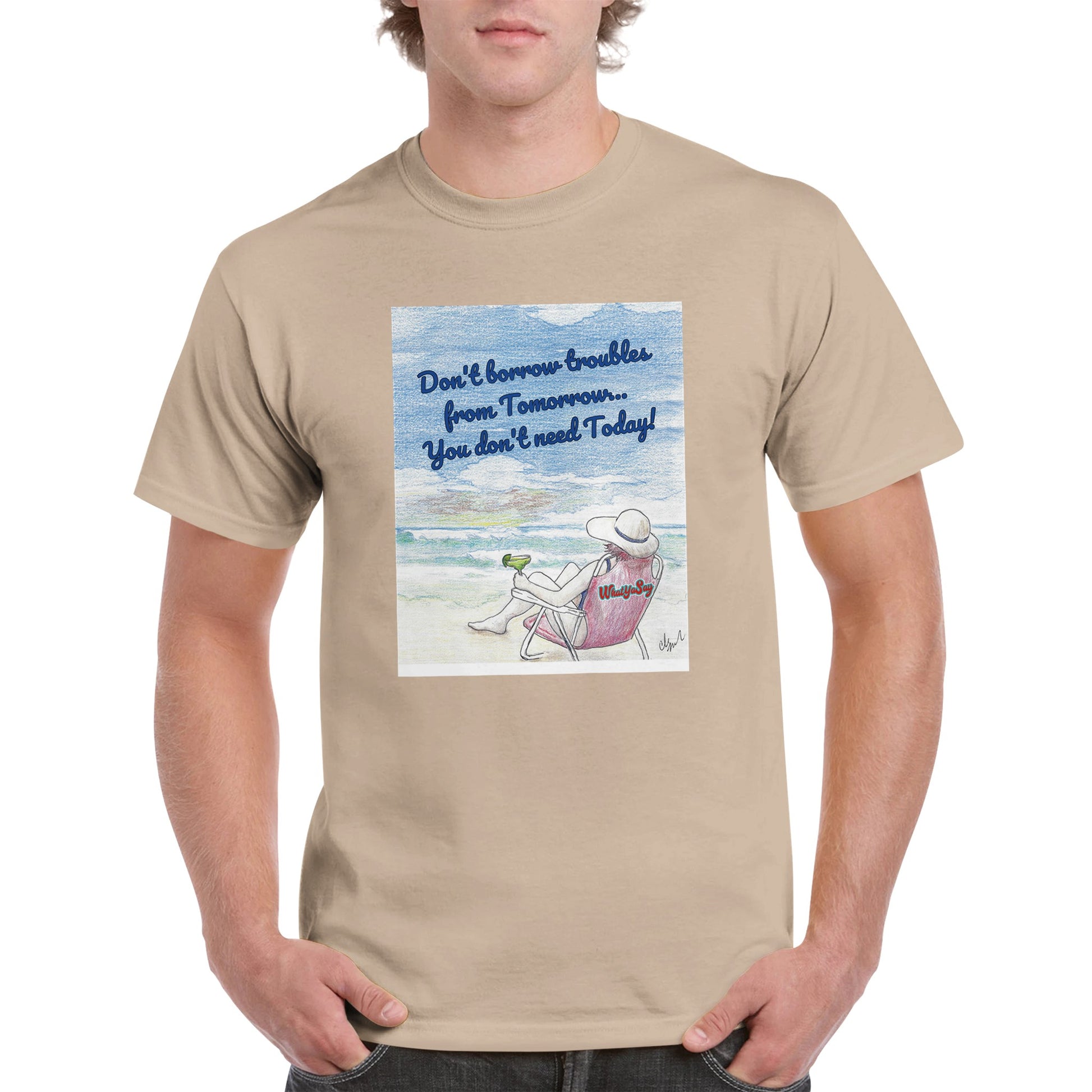 A sand heavyweight Unisex Crewneck t-shirt with original artwork and motto Don’t borrow troubles from Tomorrow… You don’t need Today! on front with WhatYa Say logo on image from WhatYa Say Apparel worn by blonde-haired male front view.