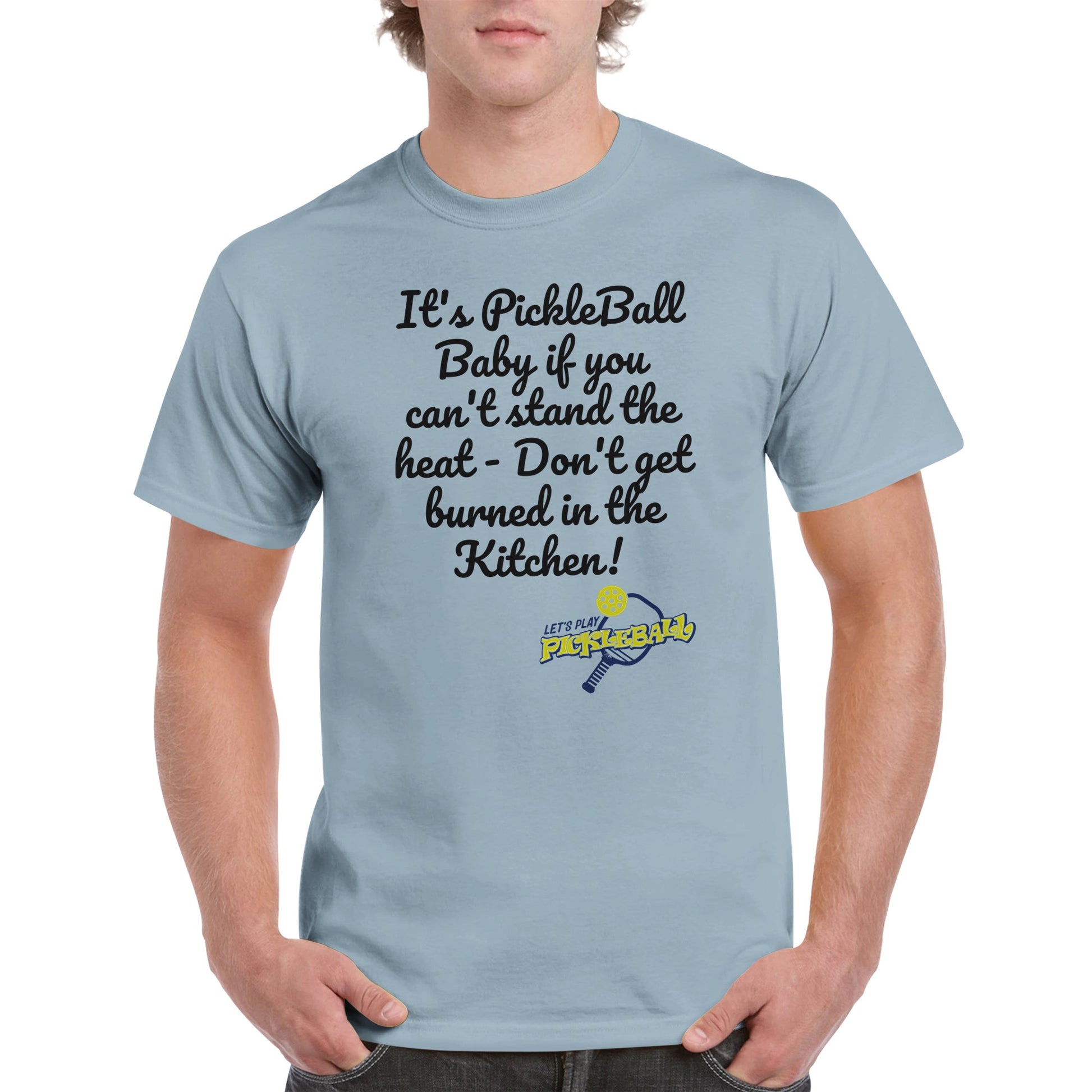 Light Blue comfortable Unisex Crewneck heavyweight cotton t-shirt with funny saying It’s PickleBall Baby if can’t stand the heat – Don’t get burned in the Kitchen!  and Let’s Play Pickleball logo on the front from WhatYa Say Apparel worn by blonde-haired male front view.