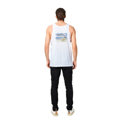 A white Premium Unisex Tank Top with original artwork and motto I need my Ass in the Sand and a Beer in my hand on back with WhatYa Say Logo on front from combed and ring-spun cotton from WhatYa Say Apparel a brown-haired male model standing back view.
