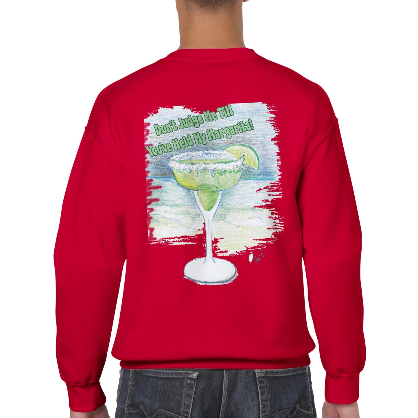 A rear view of short haired male model wearing a red Classic Unisex Crewneck sweatshirt with original artwork and motto Don’t Judge Me Till You’ve Held my margarita on back and Whatya Say logo on front from WhatYa Say Apparel.