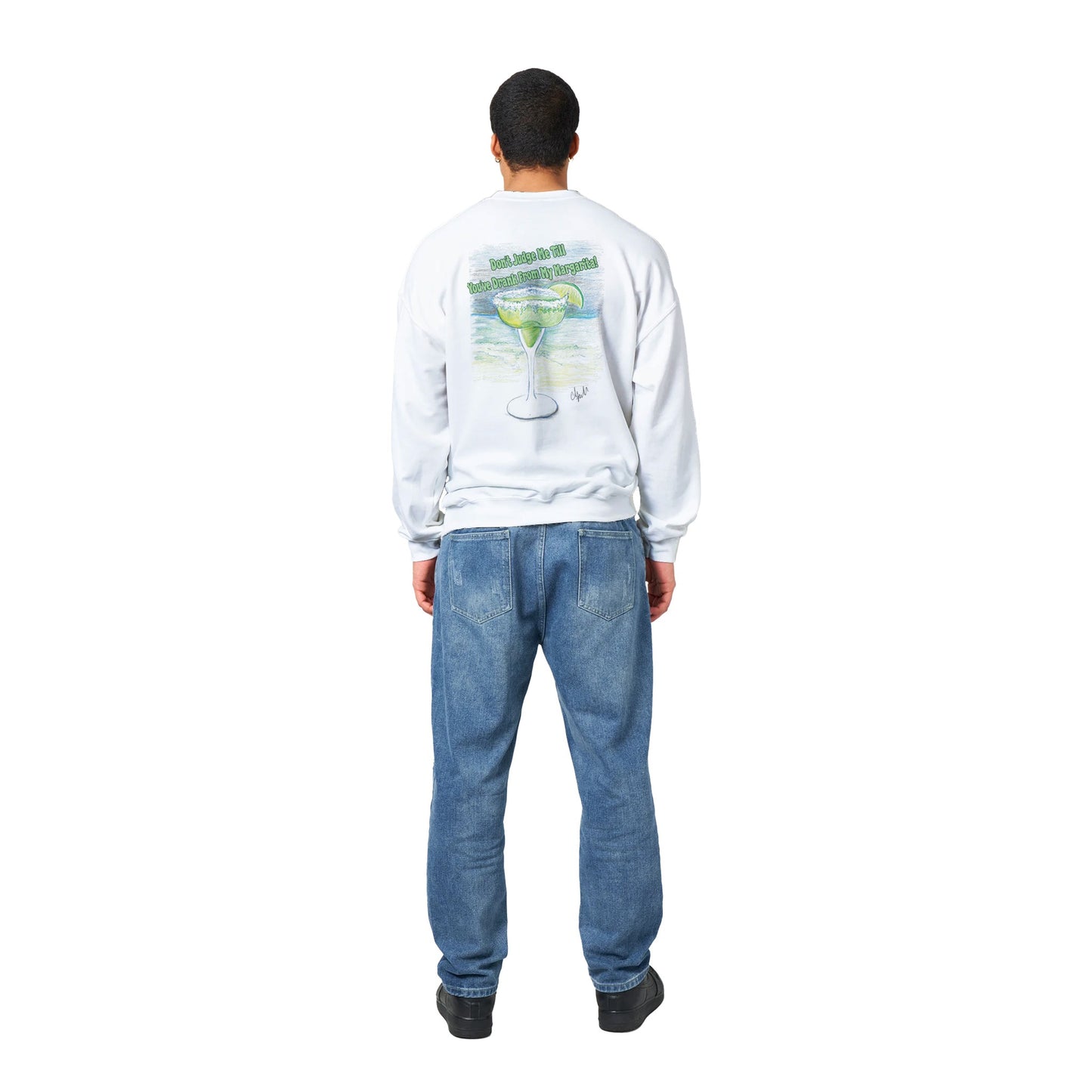 A white Classic Unisex Crewneck sweatshirt with original artwork and motto Don’t Judge Me Till You’ve Drank From My Margarita on back and Whatya Say logo on front from WhatYa Say Apparel worn by a standing short haired male model rear view.