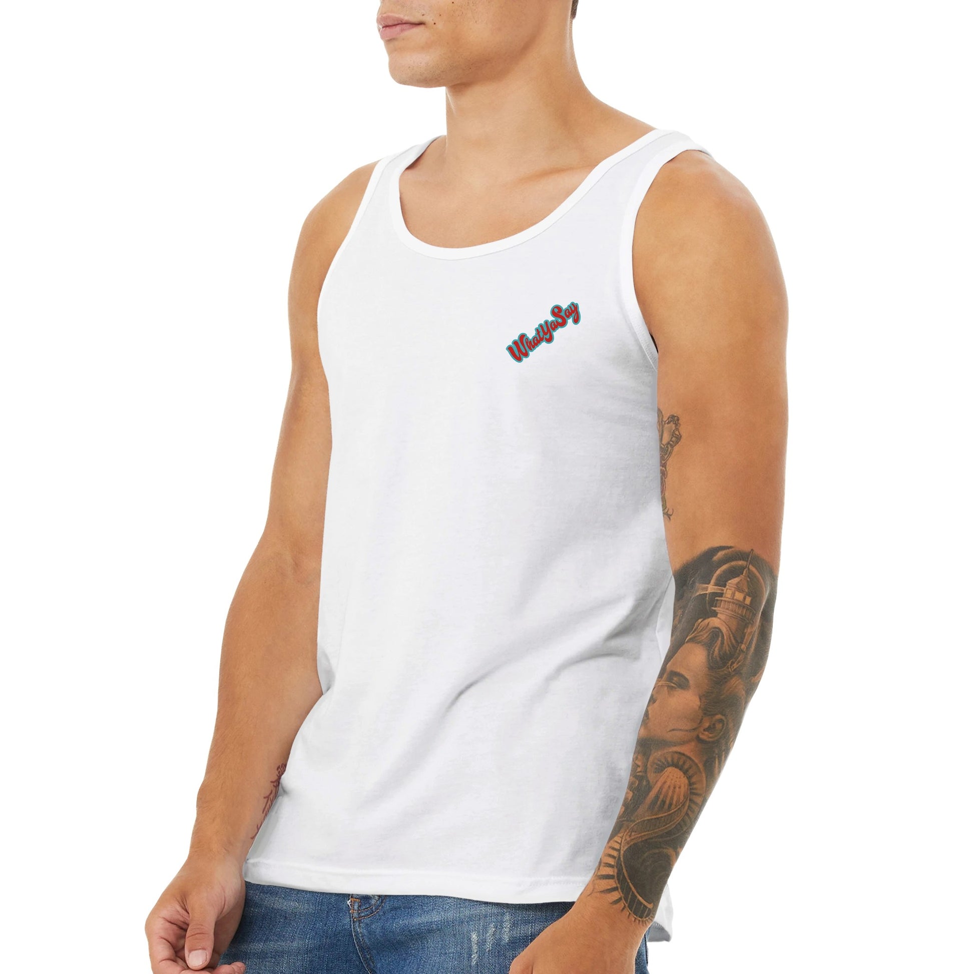 A white Premium Unisex Tank Top with original artwork and motto I need my Ass in the Sand and a Beer in my hand on back with WhatYa Say Logo on front from combed and ring-spun cotton from WhatYa Say Apparel a short-haired male model standing side front view.