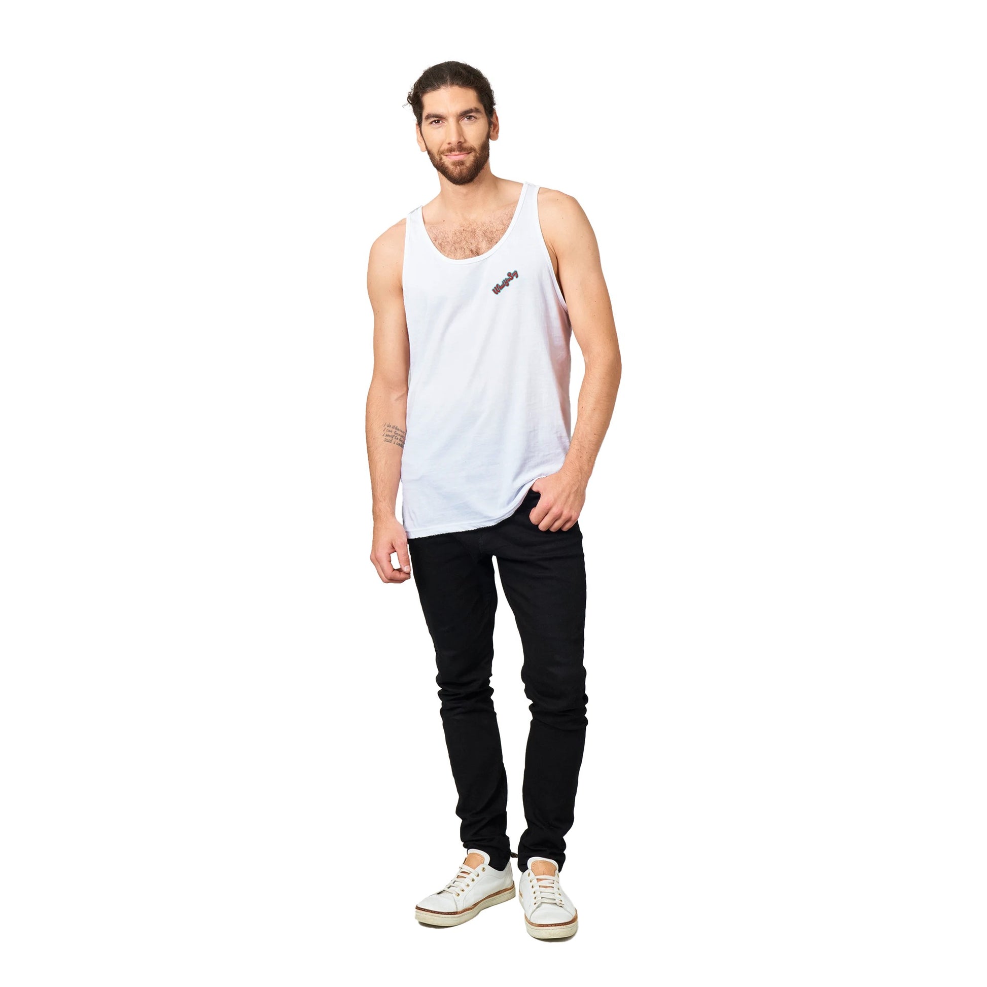 A white Premium Unisex Tank Top with original artwork and motto I need my Ass in the Sand and a Beer in my hand on back with WhatYa Say Logo on front from combed and ring-spun cotton from WhatYa Say Apparel a brown-haired male model standing front view.