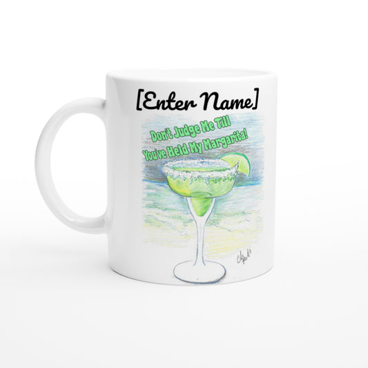 Personalized white ceramic 11oz mug with motto Don't Judge Me till You've Held my Margarita dishwasher and microwave safe ceramic coffee mug from WhatYa Say Apparel.