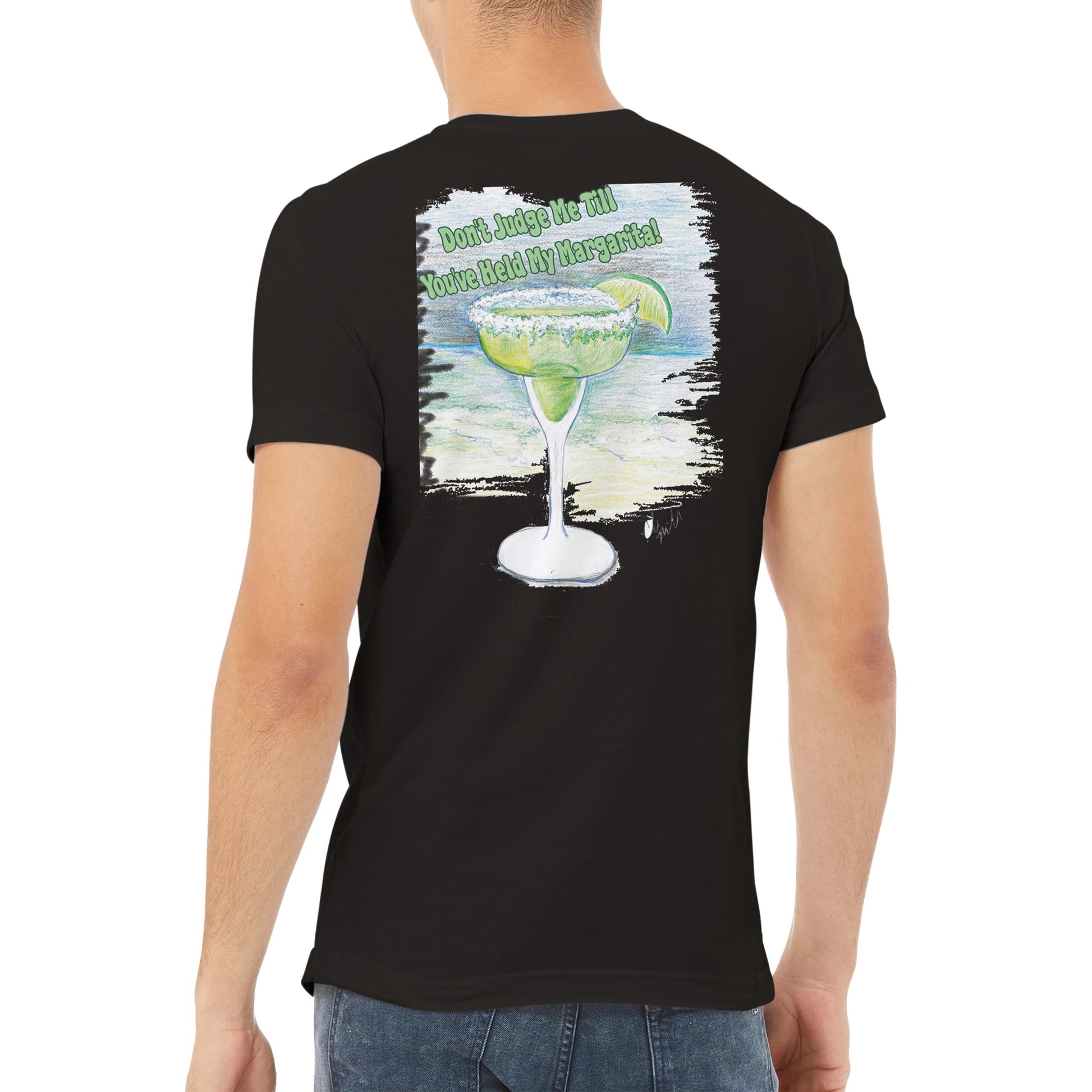 A brown-haired male wearing a WhatYa Say Black premium unisex v-neck t-shirt with original artwork and motto Don’t Judge Me Till You’ve Held My Margarita on back from WhatYa Say Apparel.