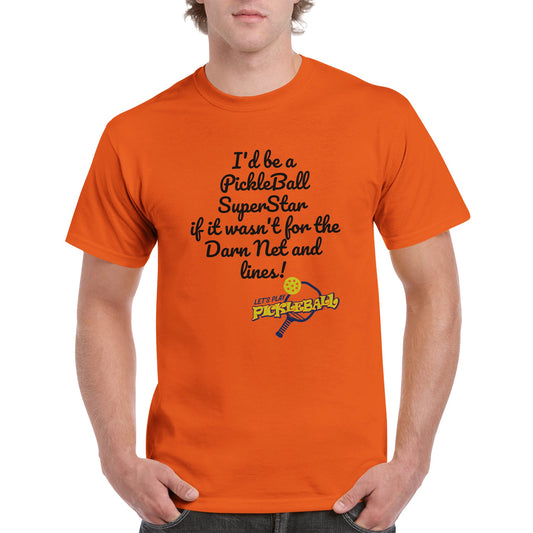 Orange comfortable Unisex Crewneck heavyweight cotton t-shirt with funny saying I’d be a PickleBall SuperStar if it wasn’t for the Darn Net and Lines and Let’s Play Pickleball logo on the front from WhatYa Say Apparel worn by blonde-haired male front view.