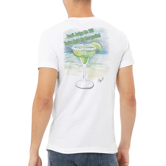 A white premium unisex v-neck t-shirt with original artwork and motto Dont Judge Me Till You've Held My Margarita  on back and WhatYa Say logo on front made with combed and ring-spun cotton from WhatYa Say Apparel worn by A brown-haired male back view.