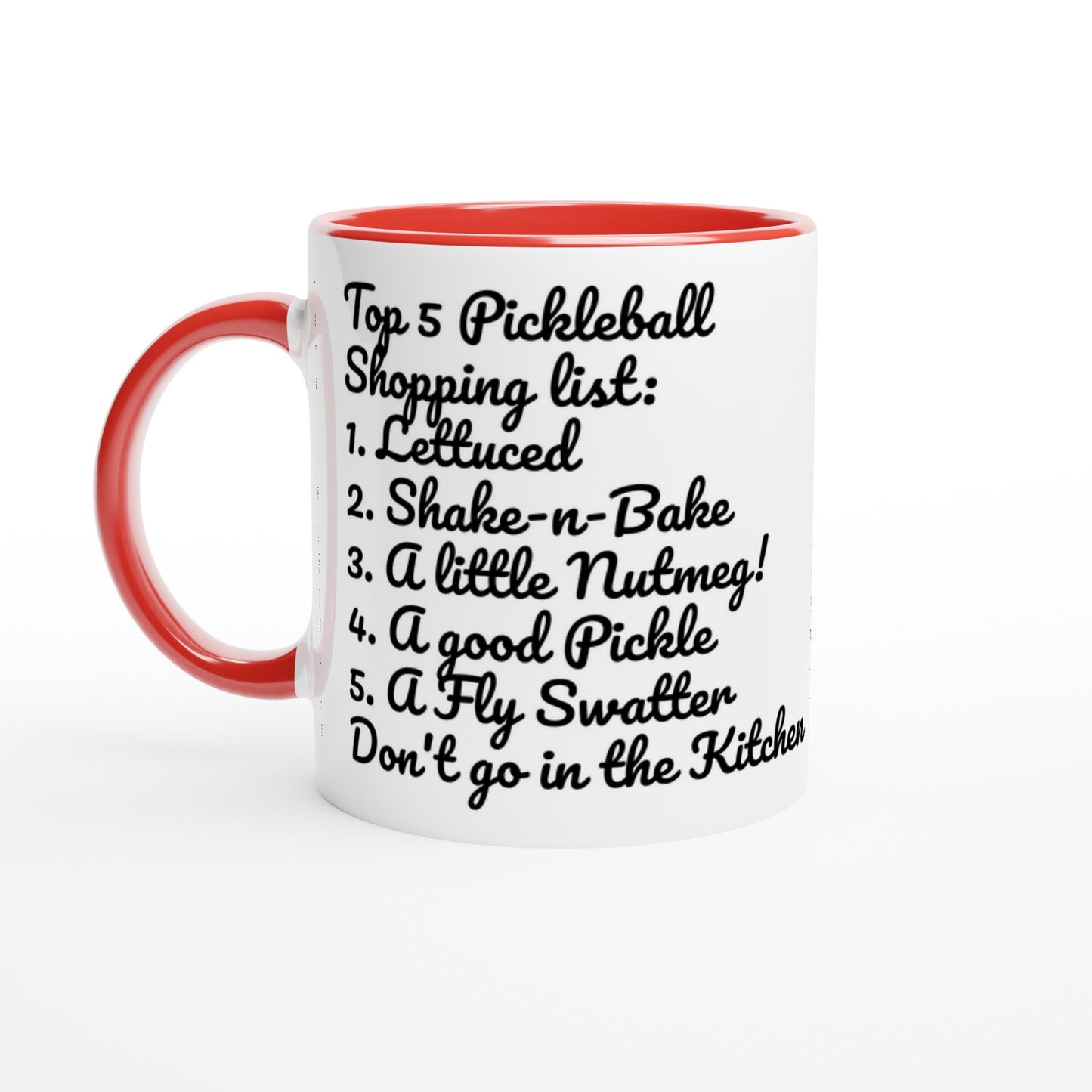 White ceramic 11oz mug with red handle original motto Top 5 Pickleball Shopping list lettuce, Shake-n-bake, Nutmeg, Pickle, a Fly Swatter Don’t go in the kitchen front side and Let's Play PickleBall logo on back dishwasher and microwave safe ceramic coffee mug from WhatYa Say Apparel front view.