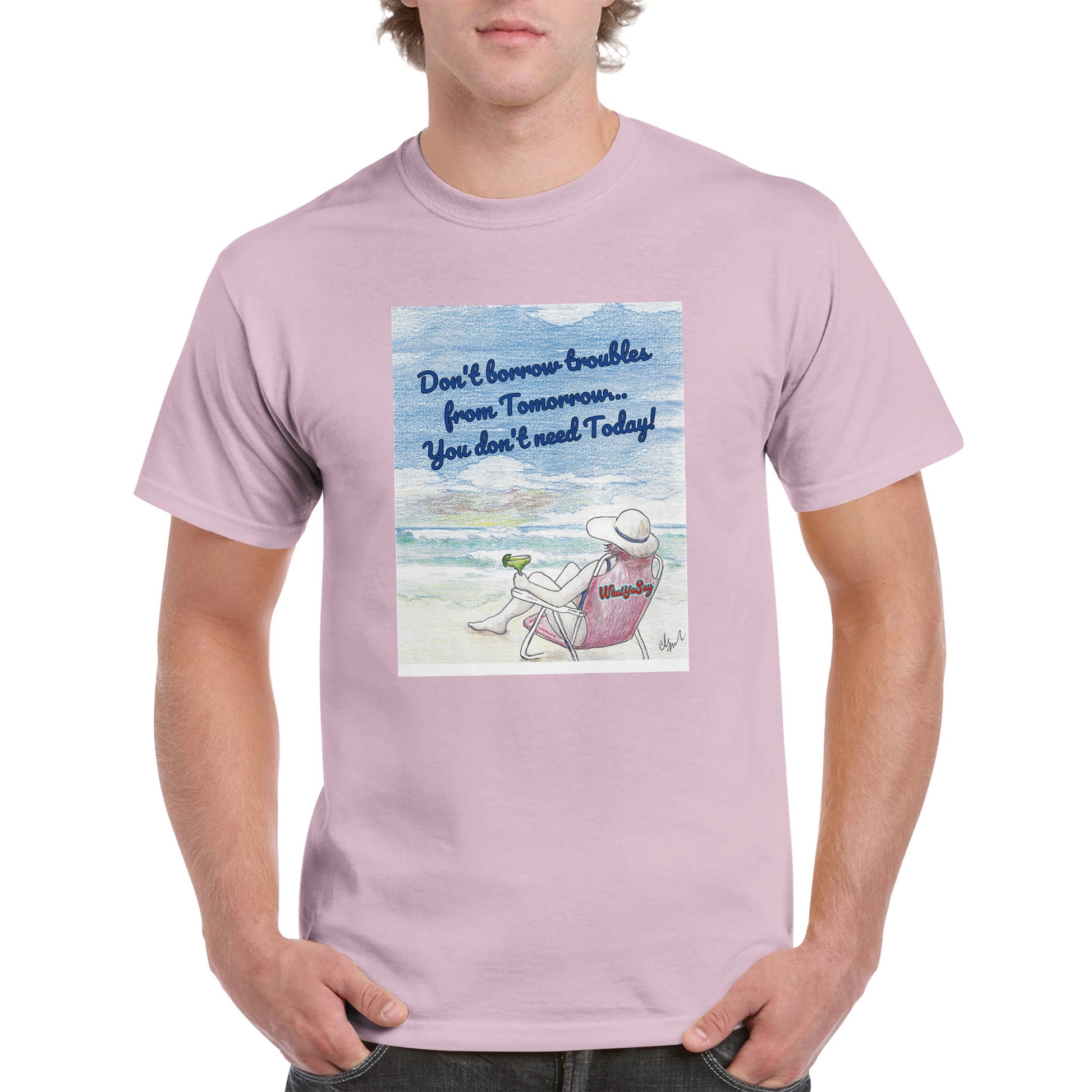 A pink heavyweight Unisex Crewneck t-shirt with original artwork and motto Don’t borrow troubles from Tomorrow… You don’t need Today! on front with WhatYa Say logo on image from WhatYa Say Apparel worn by blonde-haired male front view.