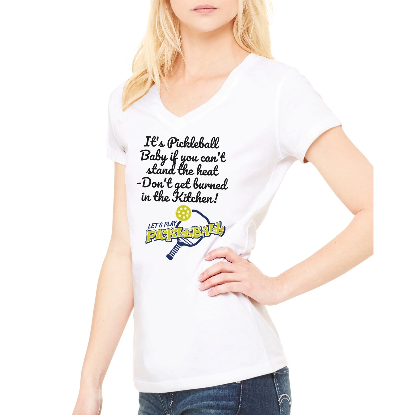 Blonde hair Female model wearing premium women’s V-neck t-shirt with original logo It's PIckleball Baby if you can't stand the heat - Don't get burned in the Kitchen and Let's Play PickleBall on front from WhatYa Say Apparel made from combed and ring-spun cotton.