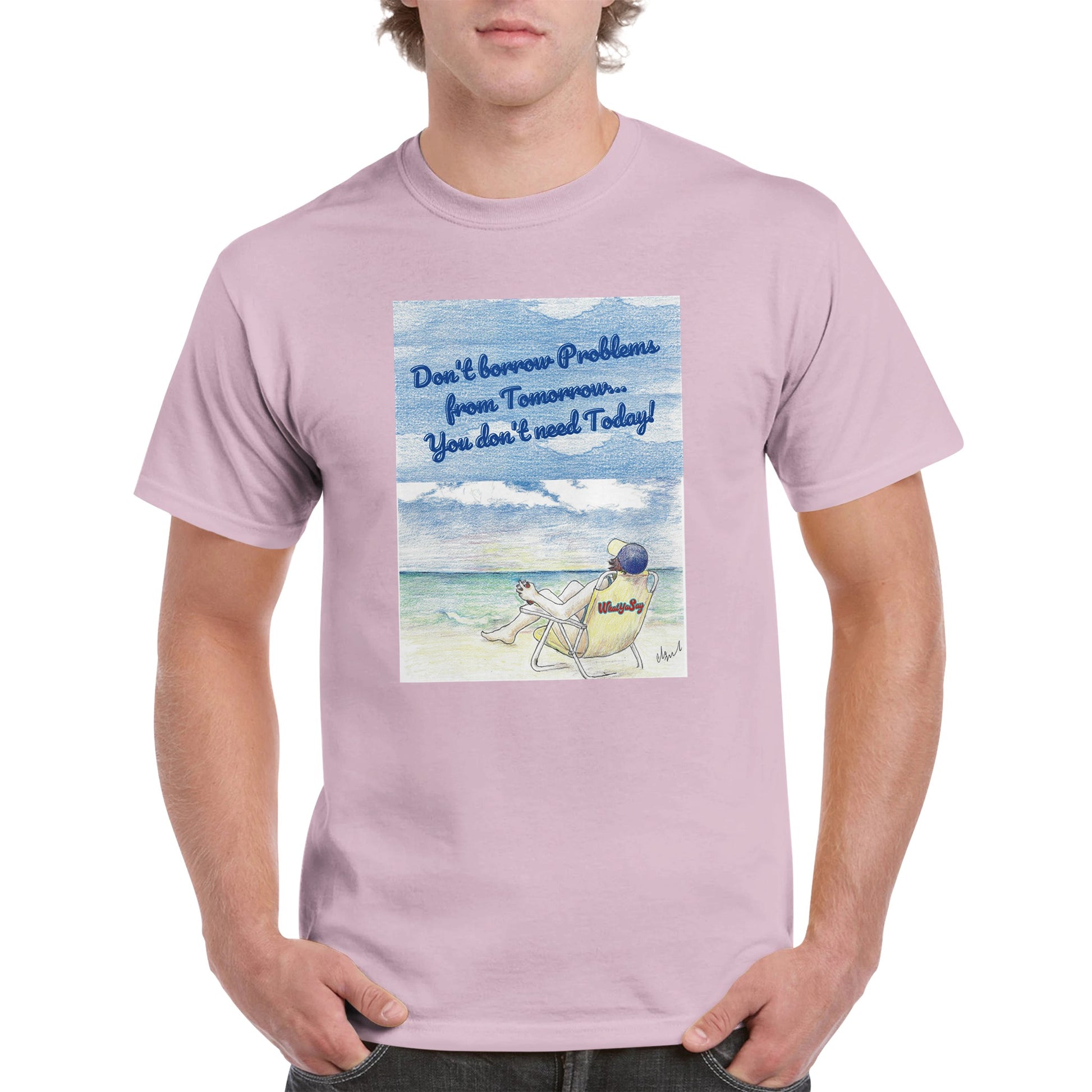 A light pink heavyweight Unisex Crewneck t-shirt with original artwork and motto Don’t borrow Problems from Tomorrow… You don’t need Today! on front with WhatYa Say logo on image from WhatYa Say Apparel worn by blonde-haired male front view.