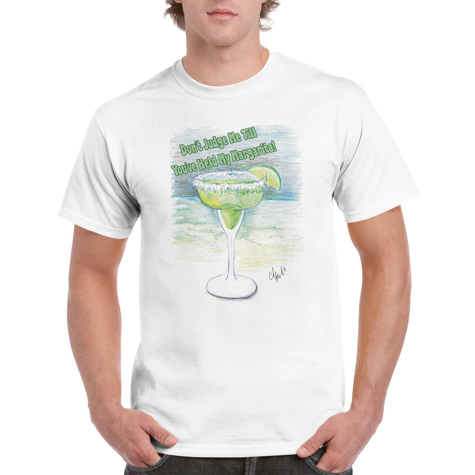 A blonde-haired male in a white heavyweight Unisex Crewneck t-shirt with original artwork and motto Don’t Judge Me Till You’ve Held my margarita on front of t-shirt from WhatYa Say Apparel.