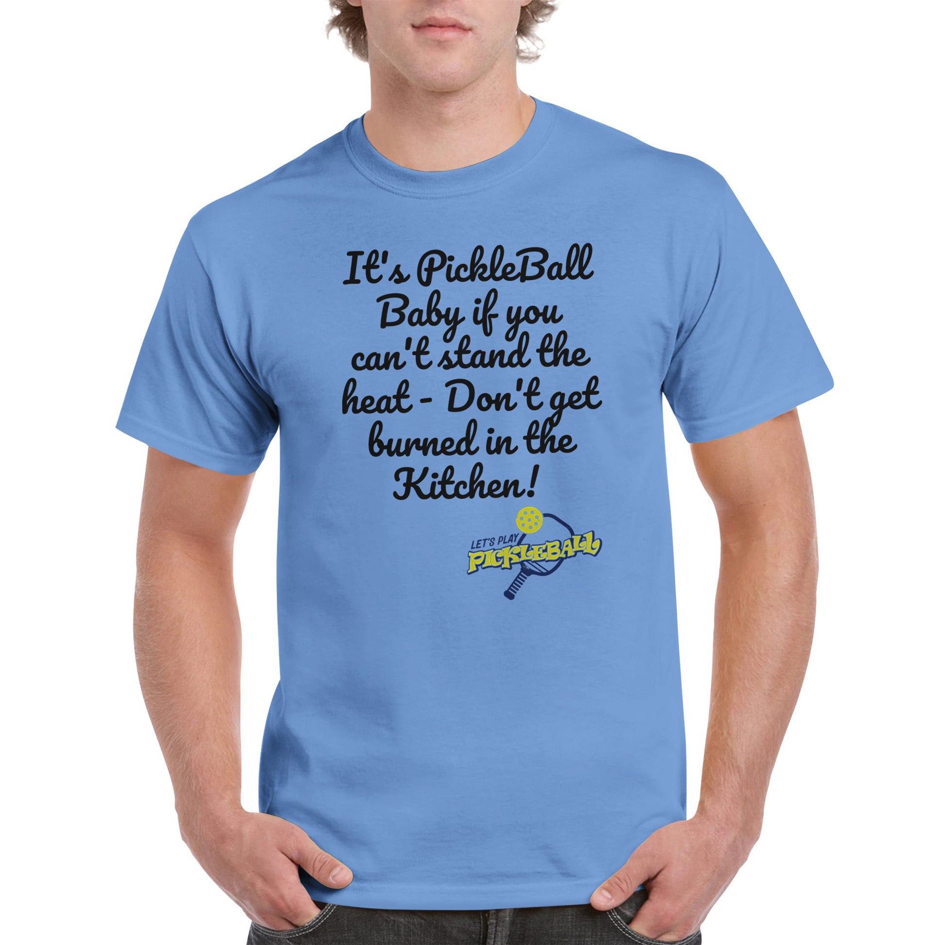 Carolina Blue comfortable Unisex Crewneck heavyweight cotton t-shirt with funny saying It’s PickleBall Baby if can’t stand the heat – Don’t get burned in the Kitchen!  and Let’s Play Pickleball logo on the front from WhatYa Say Apparel worn by blonde-haired male front view.