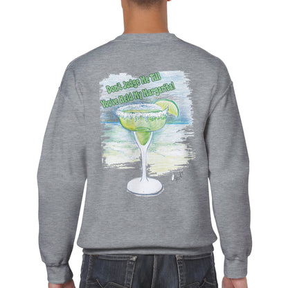 A rear view of short haired male model wearing a ash Classic Unisex Crewneck sweatshirt with original artwork and motto Don’t Judge Me Till You’ve Held my margarita on back and Whatya Say logo on front from WhatYa Say Apparel.