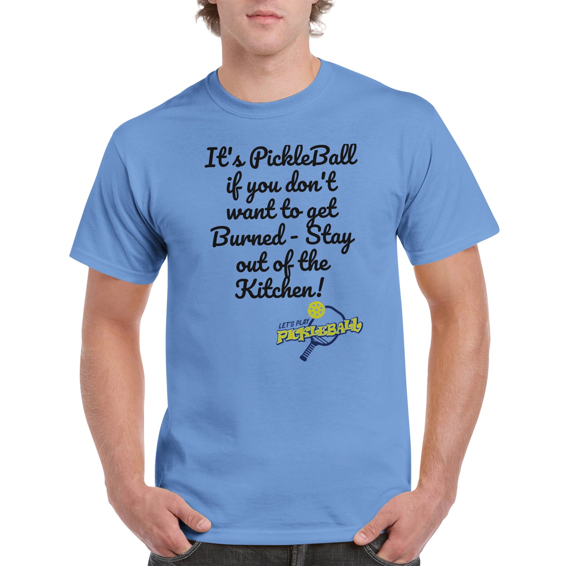 Carolina Blue comfortable Unisex Crewneck heavyweight cotton t-shirt with funny saying It’s PickleBall if you don’t want to get Burned – Stay out of the Kitchen! and Let’s Play Pickleball logo on the front from WhatYa Say Apparel worn by blonde-haired male front view.