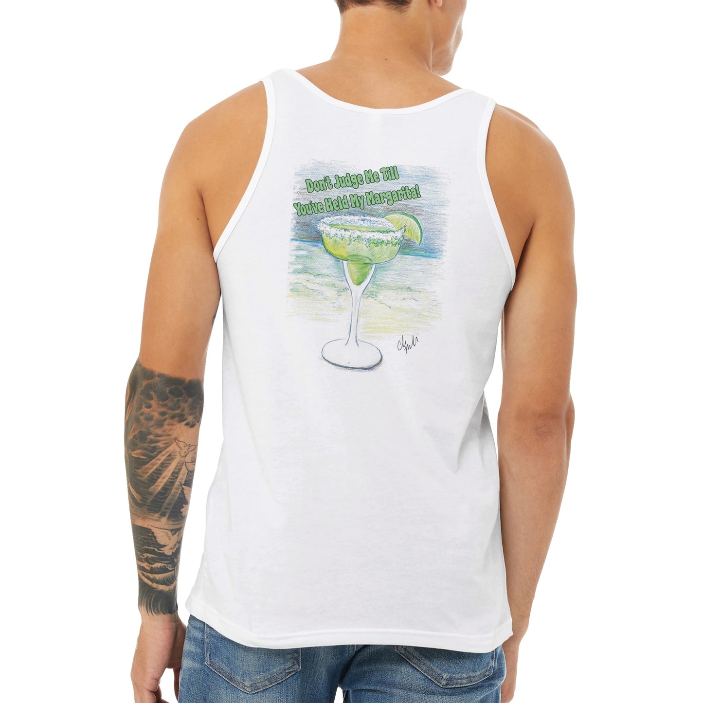A white Premium Unisex Tank Top with original artwork and motto Don’t Judge Me Till You’ve Held my Margarita on back with WhatYa Say Logo on front from combed and ring-spun cotton from WhatYa Say Apparel a brown-haired male model back view.