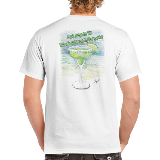 A blonde-haired male wearing a white heavyweight Unisex Crewneck t-shirt from WhatYa Say Apparel with original artwork and motto Don’t Judge Me Till You’ve Drank from my margarita on back of t-shirt.
