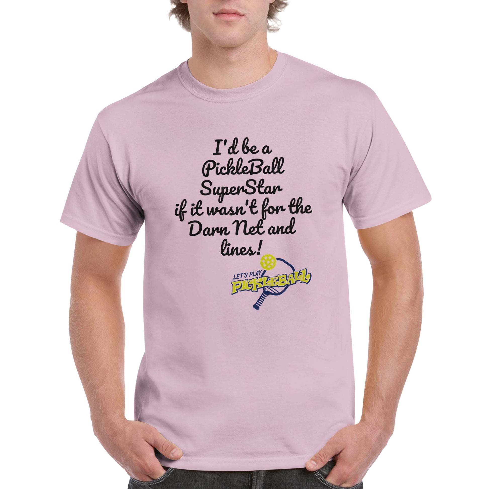 Light Pink comfortable Unisex Crewneck heavyweight cotton t-shirt with funny saying I’d be a PickleBall SuperStar if it wasn’t for the Darn Net and Lines and Let’s Play Pickleball logo on the front from WhatYa Say Apparel worn by blonde-haired male front view.