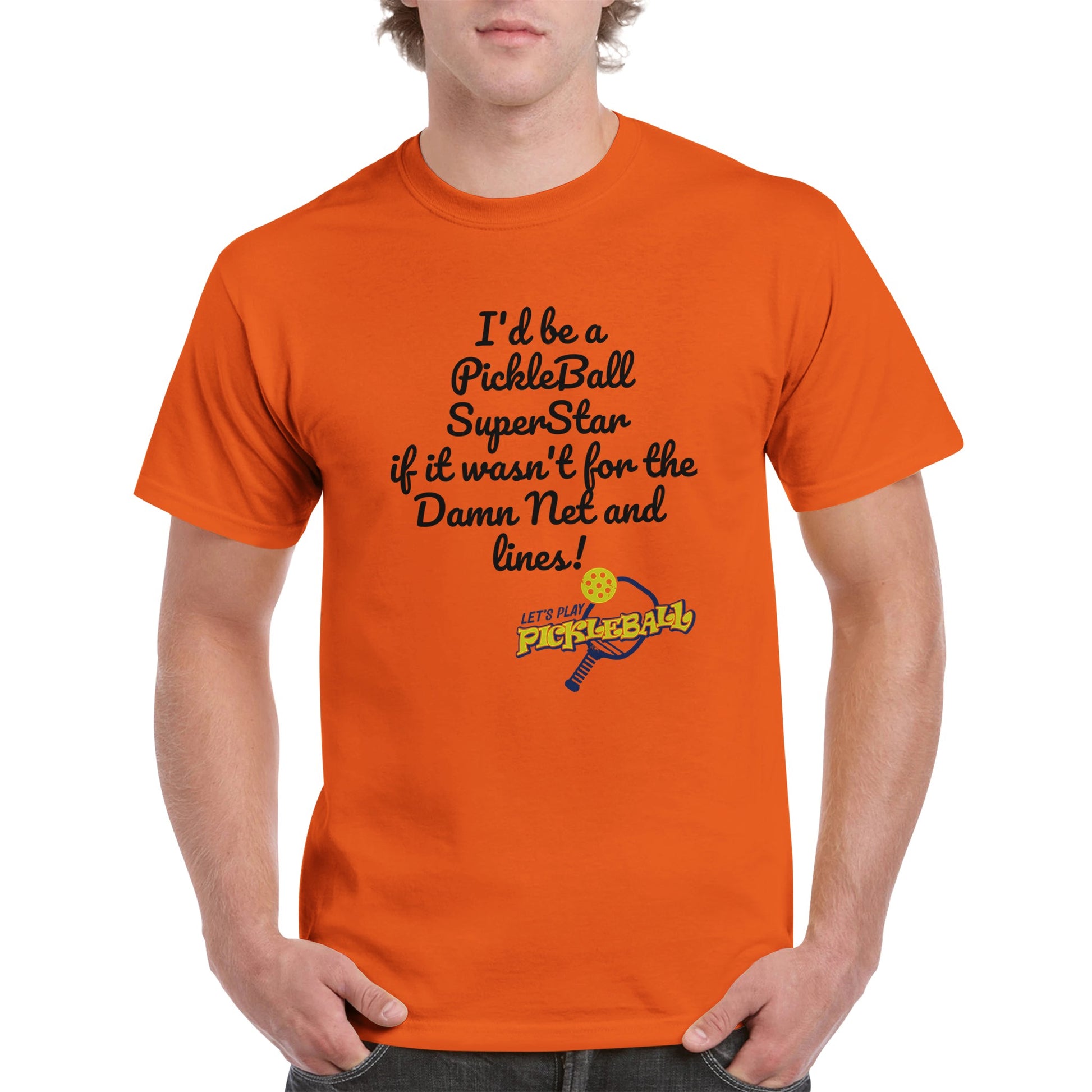 Orange comfortable Unisex Crewneck heavyweight cotton t-shirt with funny saying I’d be a PickleBall SuperStar if it wasn’t for the Damn Net and Lines and Let’s Play Pickleball logo on the front from WhatYa Say Apparel worn by blonde-haired male front view.