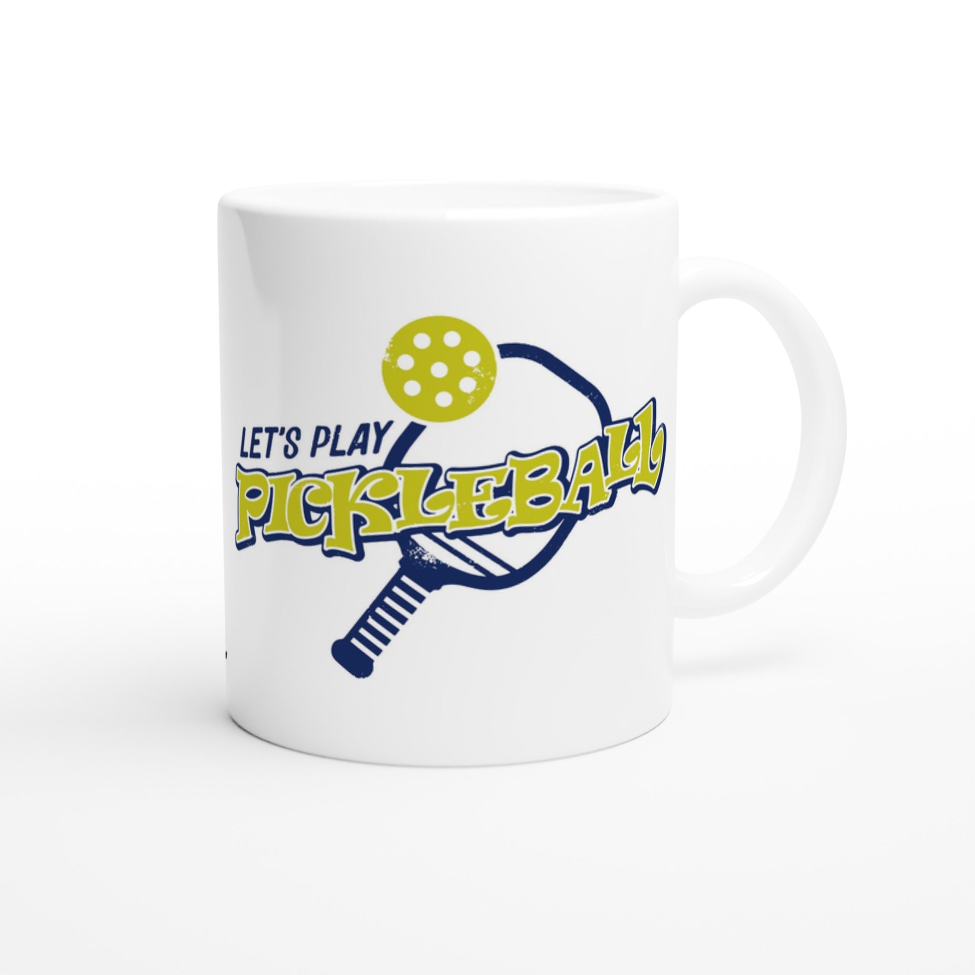 White ceramic 11oz mug with original motto Top 5 Pickleball Shopping list lettuce, Shake-n-bake, Nutmeg, Pickle, a Fly Swatter Don’t go in the kitchen front side and Let's Play PickleBall logo on back coffee mug dishwasher and microwave safe from WhatYa Say Apparel back view.