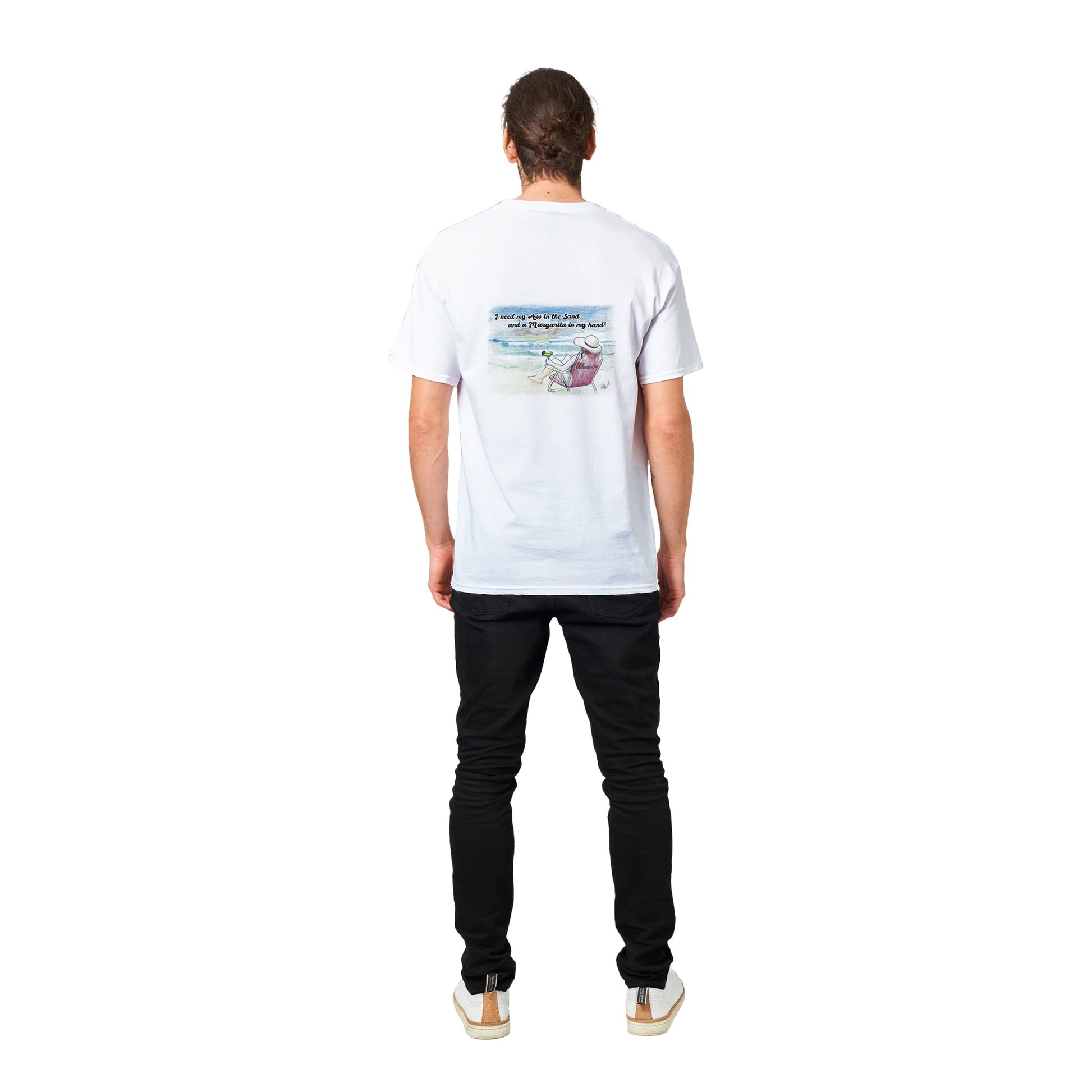 A white heavyweight Unisex Crewneck t-shirt with original artwork and I need my Ass in the Sand and a Margarita in my hand on back with WhatYa Say logo on front from WhatYa Say apparel worn by short brown-haired male model standing facing rear.