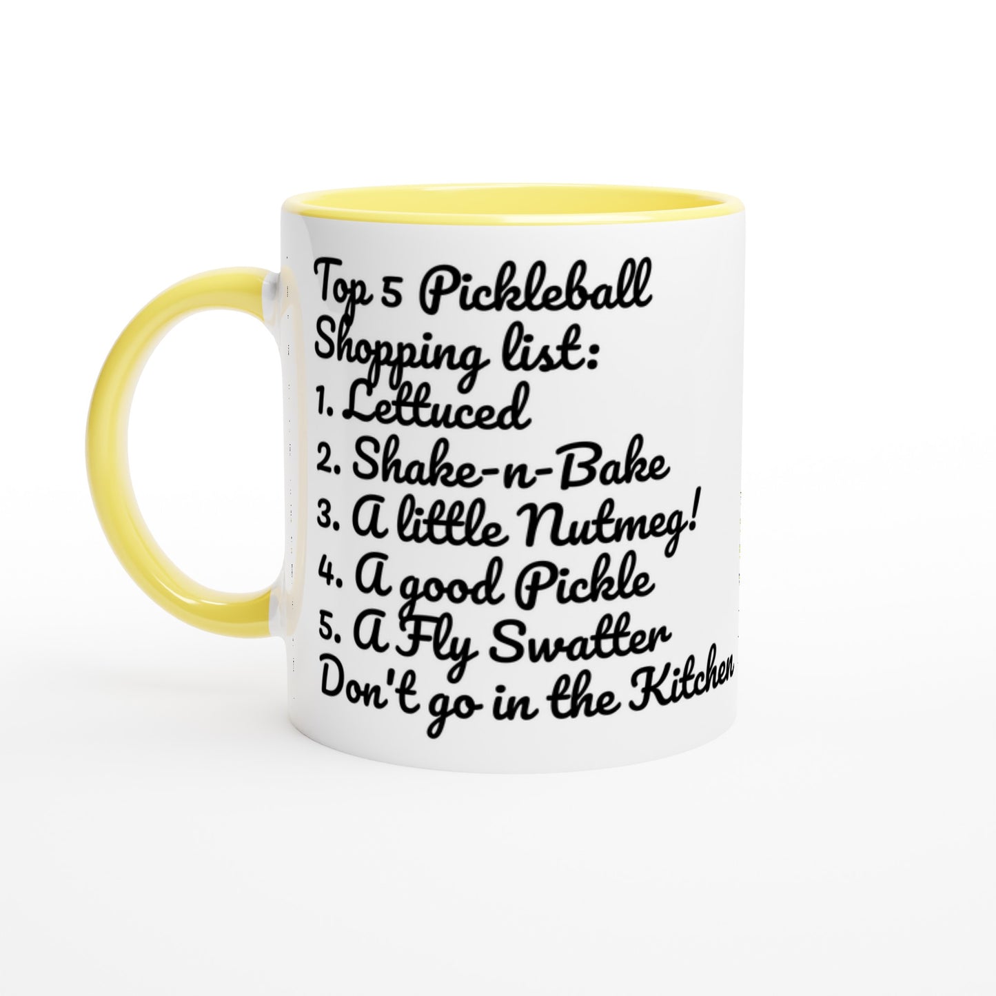White ceramic 11oz mug with yellow handle original motto Top 5 Pickleball Shopping list lettuce, Shake-n-bake, Nutmeg, Pickle, a Fly Swatter Don’t go in the kitchen front side and Let's Play PickleBall logo on back dishwasher and microwave safe ceramic coffee mug from WhatYa Say Apparel front view.