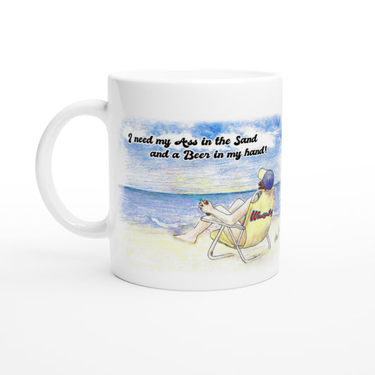 White ceramic 11oz mug with motto I need my Ass in the Sand and a Beer in my hand front side and WhatYa Say logo on back dishwasher and microwave safe ceramic coffee mug from WhatYa Say Apparel front view.